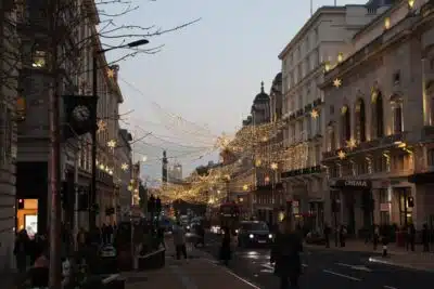 Oxford Street London at dusk with street lights glowing. By Alicja Ziajowska on Unsplash.