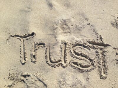 Trust written in the sand. By LisaLoveTo Dance on pixabay