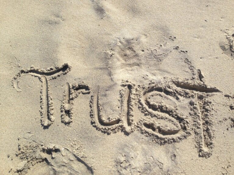 Trust written in the sand. By LisaLoveTo Dance on pixabay