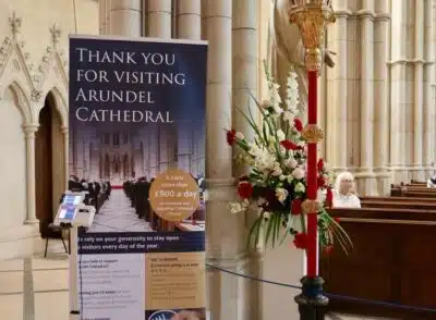 A contactless donation point and sign in Arundel Cathedral
