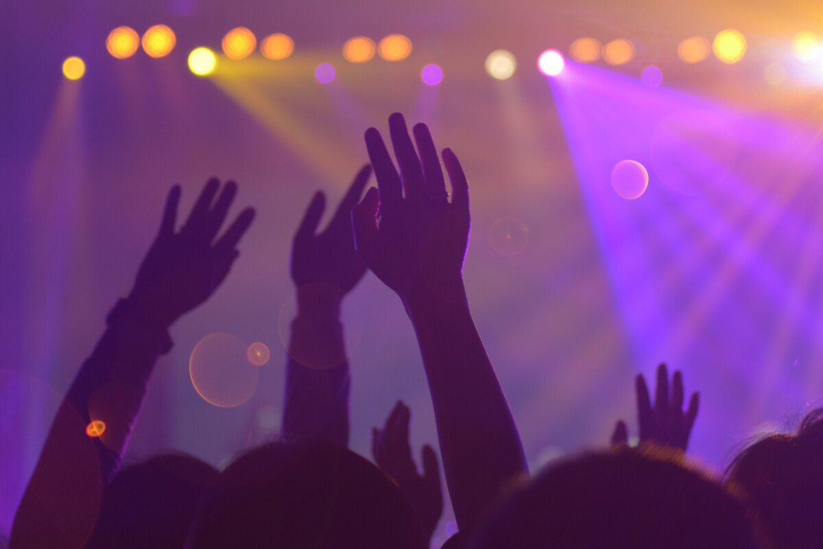 Hands raised at a concert