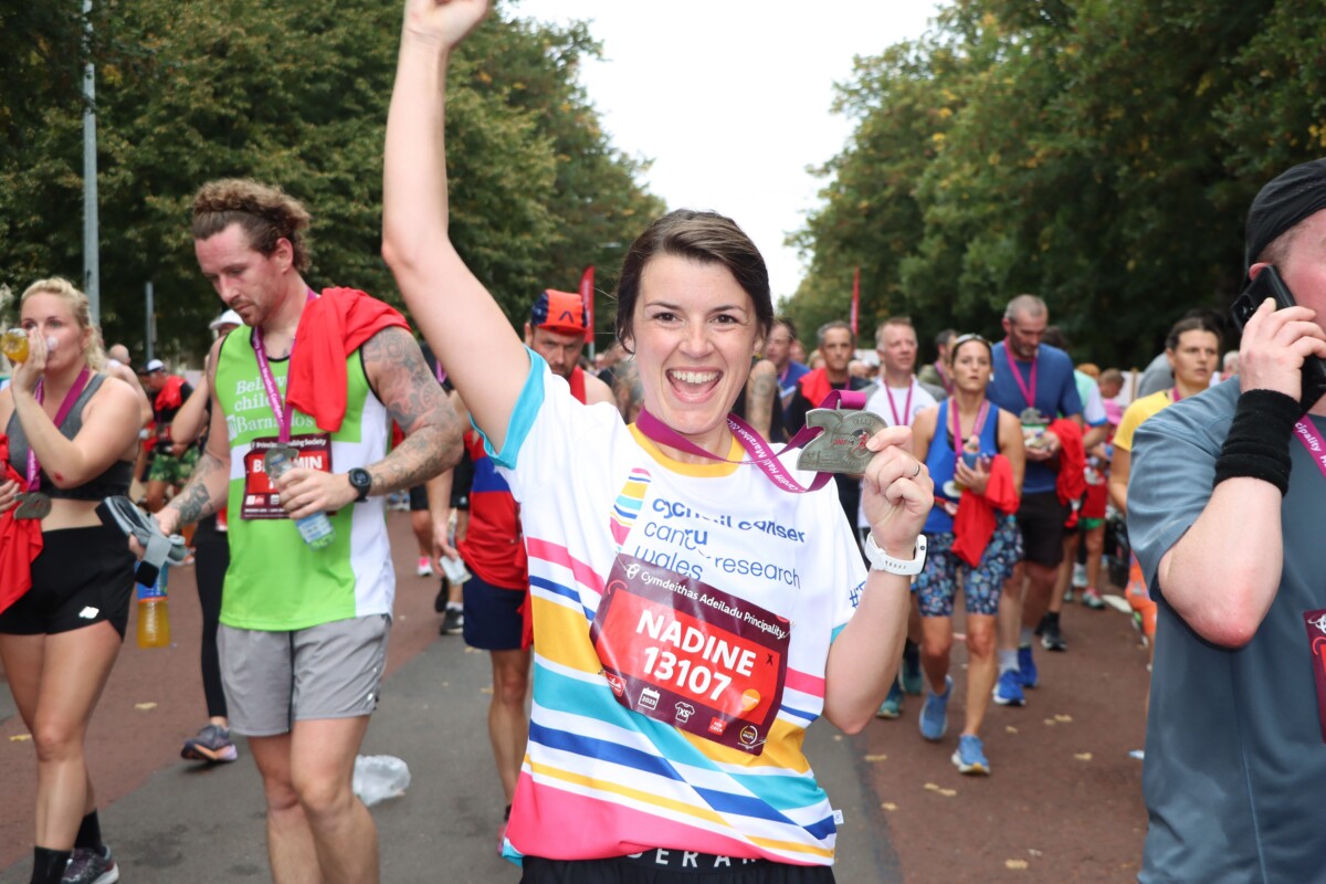 A jubilant runner punches the air during a race.