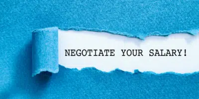 Negotiate your salary - typed text appearing via a torn-off section of blue paper on top. Source: Canva.com