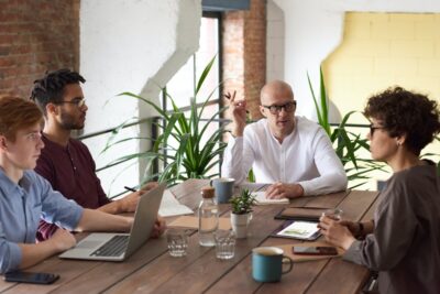 4 people - 3 men and a woman in a meeting. By Fauxels on Pexels