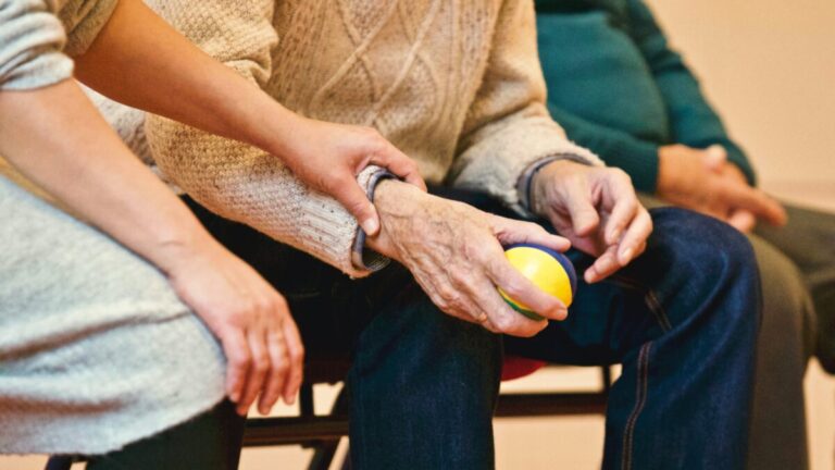 older person holding a ball. By Matthias Zomer on PExels
