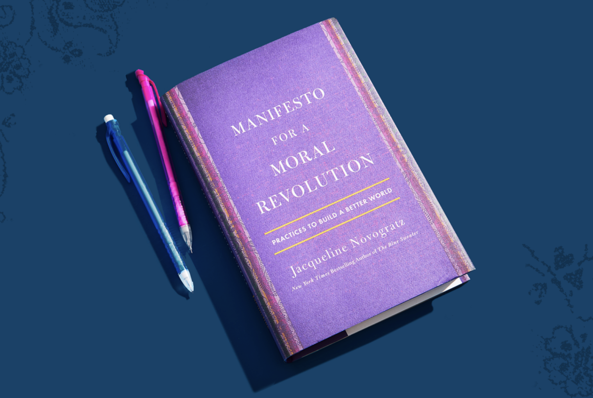 Cover of Manifesto for a Moral Revolution next to two pens.