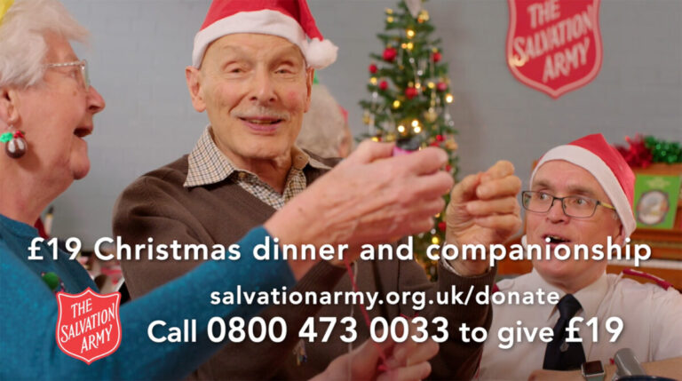 A still from the Salvation Army's 2023 Christmas appeal film, showing older people celebrating and the message: £19 Christmas dinner and companionship