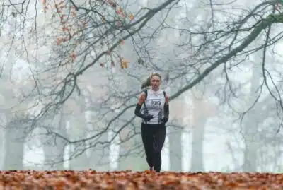 A female runner in an autumnal Richmond Park. By Fil Mazzarino on unsplash