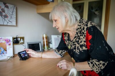 An older woman looks at her smart meter. By the Centre for Ageing Better
