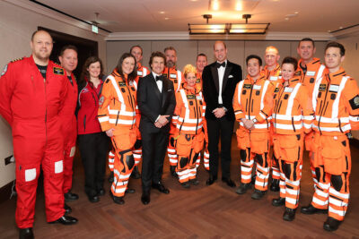 Tom Cruise and the Prince of Wales line up in a group shot with London's Air Ambulance Charity's staff. Credit: The Prince & Princess of Wales