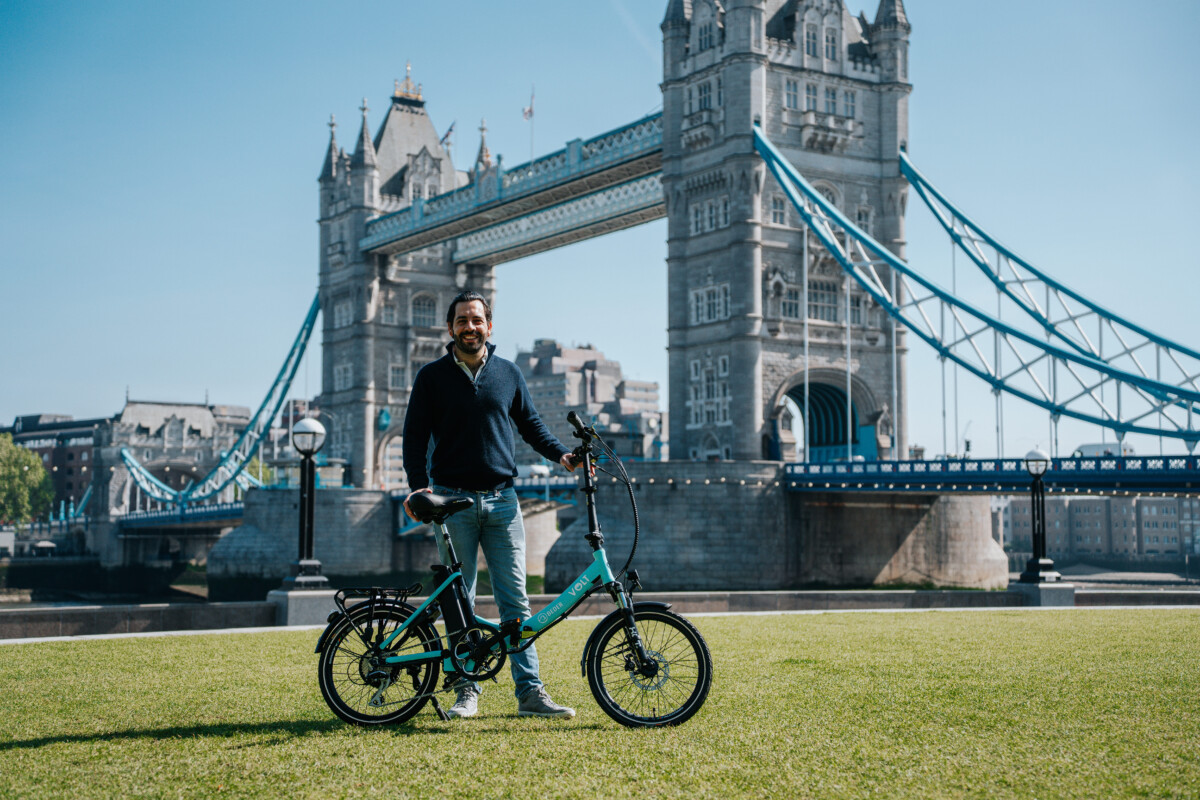 Razzak Mirjan, Beder Founder, with Beder wrapped VOLT Metro e-bike, in front of Tower Bridge