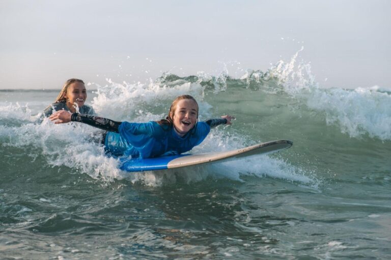 A happy looking child on a surf board – from The Wave Project charity
