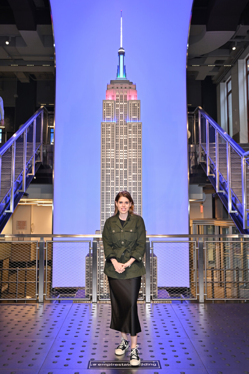 HRH Princess Beatrice in front of a large image of the Empire State Building.