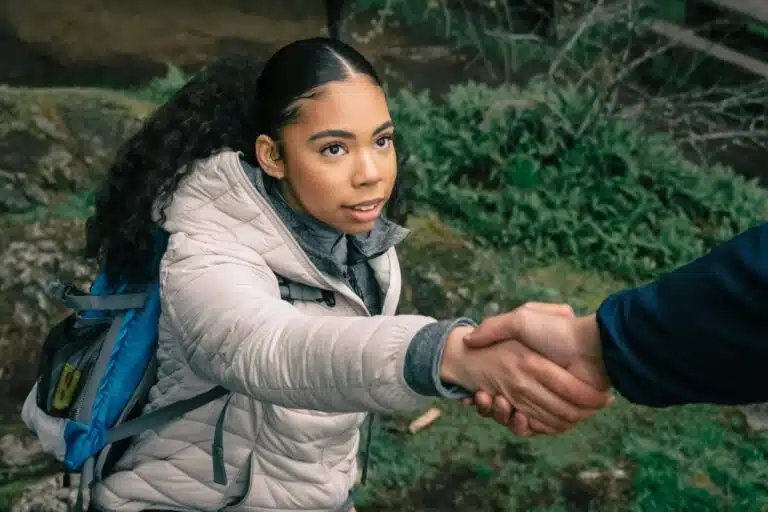 A young woman takes a helping hand on a walk. By PNW Production on pexels