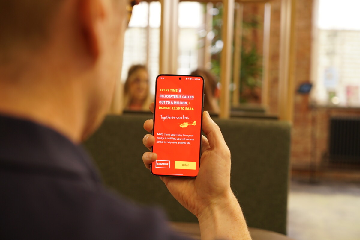 A man uses the new East Anglian Air Ambulance fundraising app. Credit: Rory Southworth