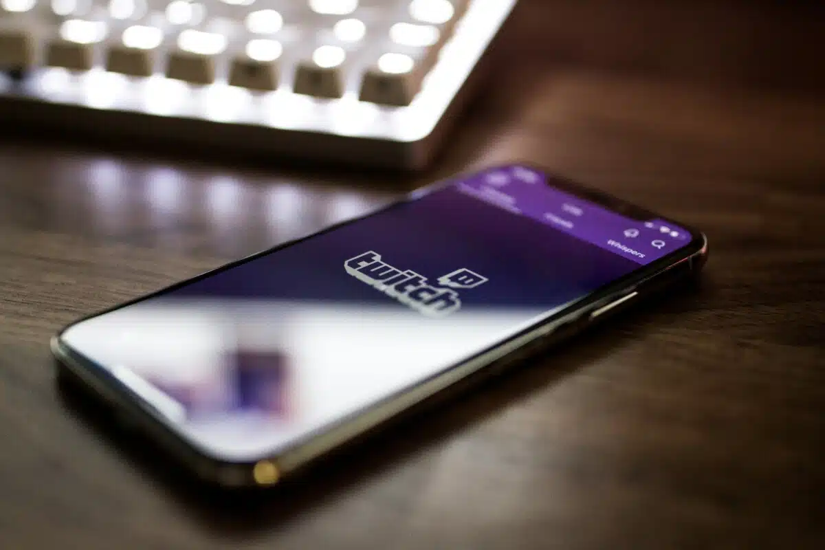 A photo of a phone showing Twitch on the screen. By Caspar Camille Rubin on Unsplash.