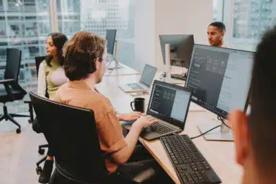 An office shot of people doing data and AI training on computers