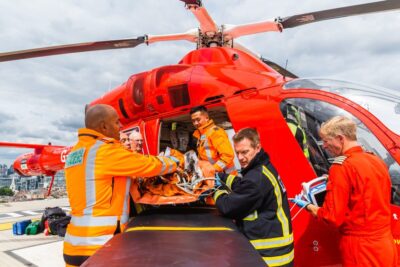 Medical staff from London's Air Ambulance Charity in action by a helicopter