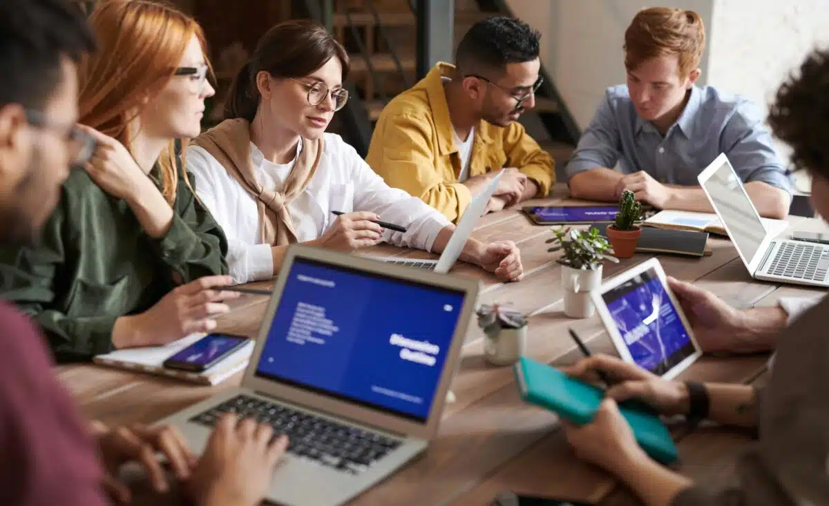 A team in an office working around a table, by Fauxels on pexels