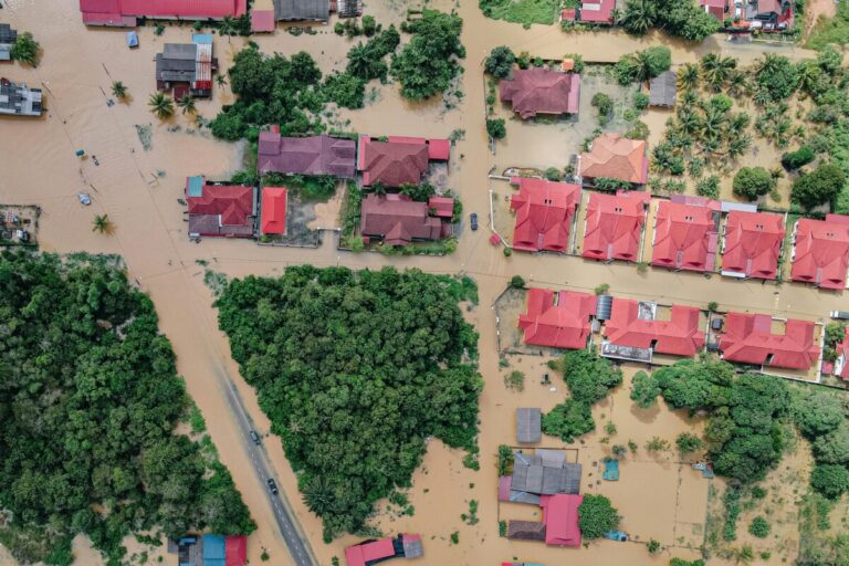 roofs of houses in a flooded area. By Pok Rie on Pexels