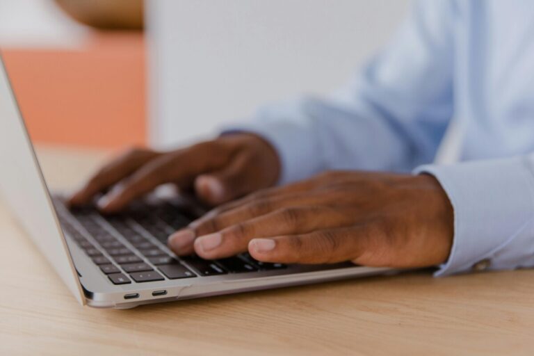 A man's hands on a laptop keyboard. By RDNE on pexels