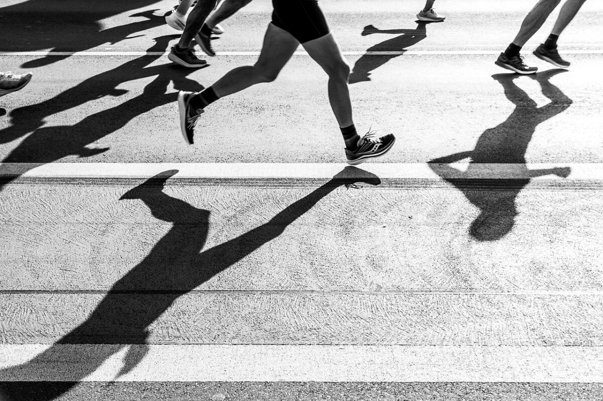 People throw shadows on the tarmac as they run in a marathon. By wal_172619 on Pixabay