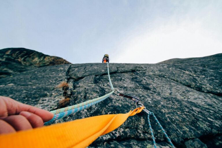 Ropes between climbers heading up a sheer rockface.