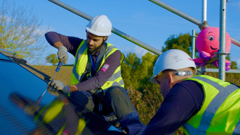 Solar panel installation on a roof by an Octopus Energy team.