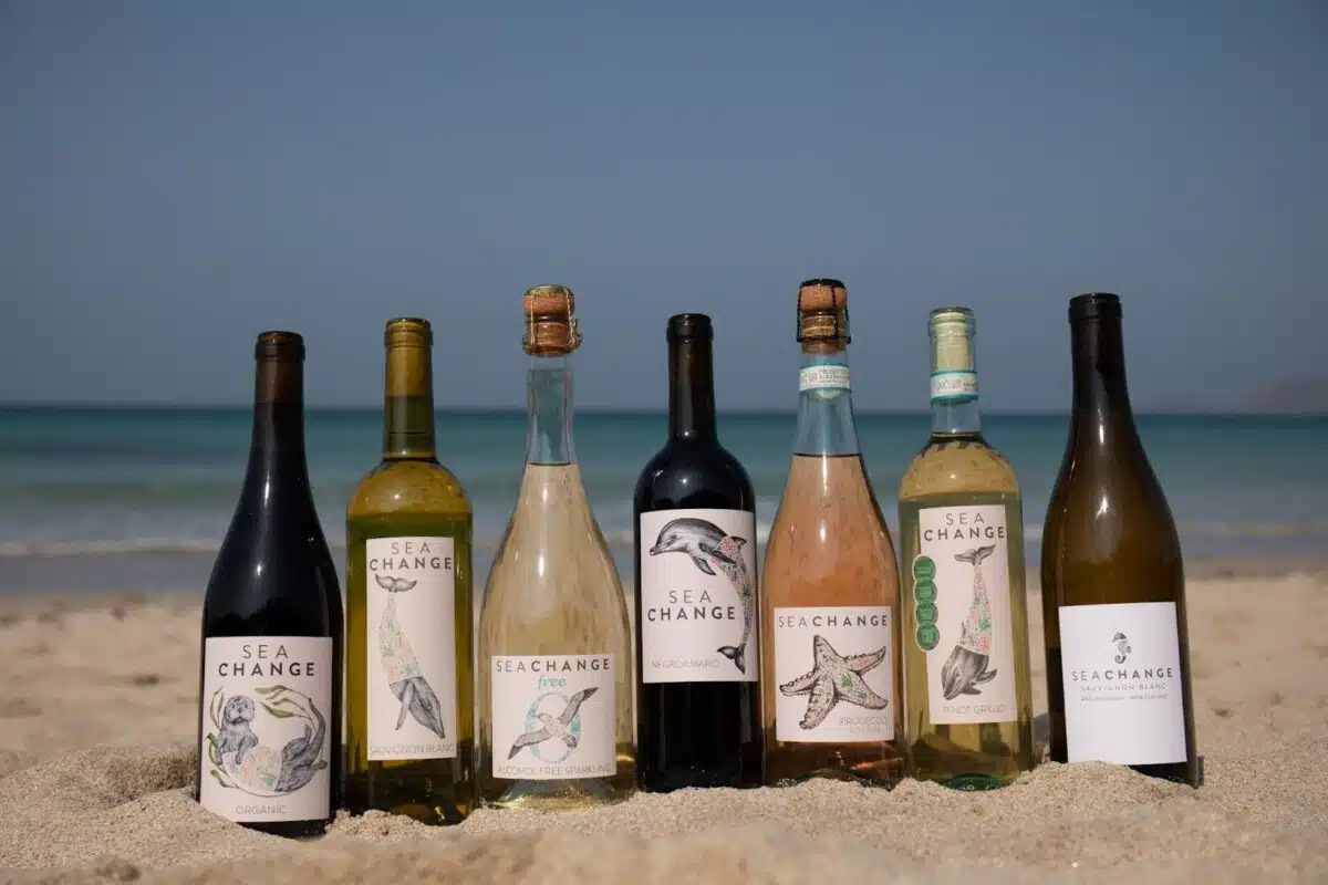 a line of Sea Change wines on a beach