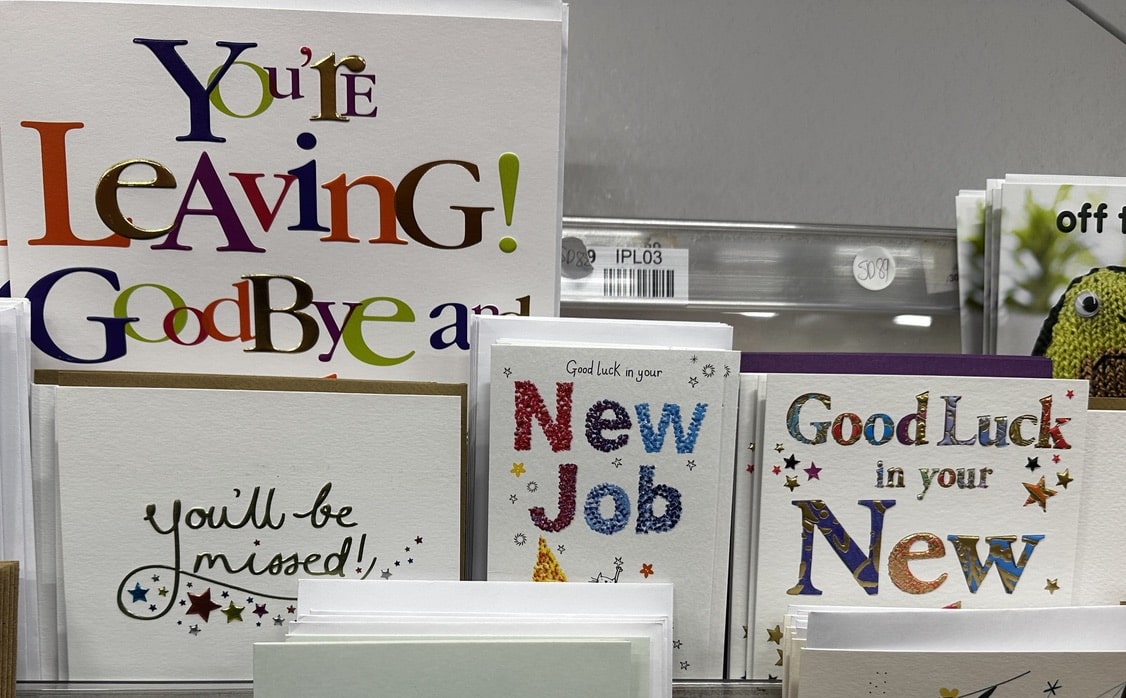 New job congratulations cards on a shop rack.