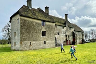 Children playing in a garden outside a Landmark Trust property.