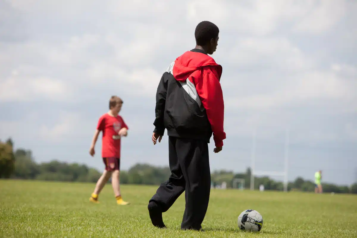 Anonymous imagery of two children playing football, taken from a project visit to London during the 2012 Sport Relief campaign on 29 July 2011. Photo by Comic Relief.