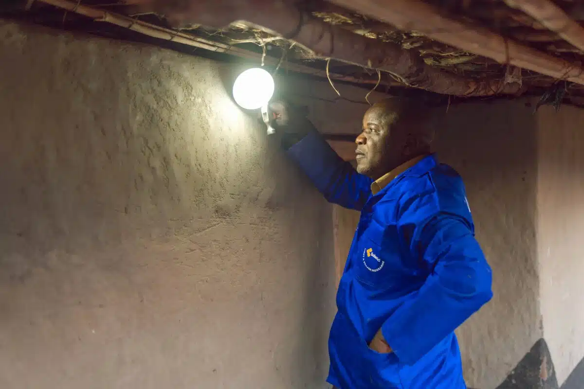 Repair Technician Rodgers Mwamba repairing a solar light at Likumbi Primary School, Zambia.