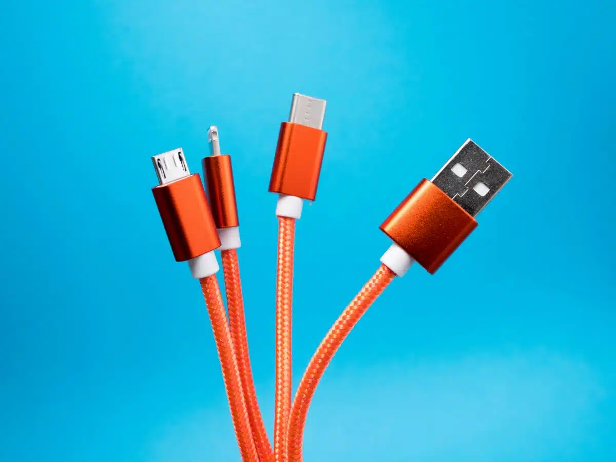 Four orange digital cables on a blue background.