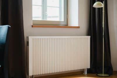 Electric radiator in front of a window.