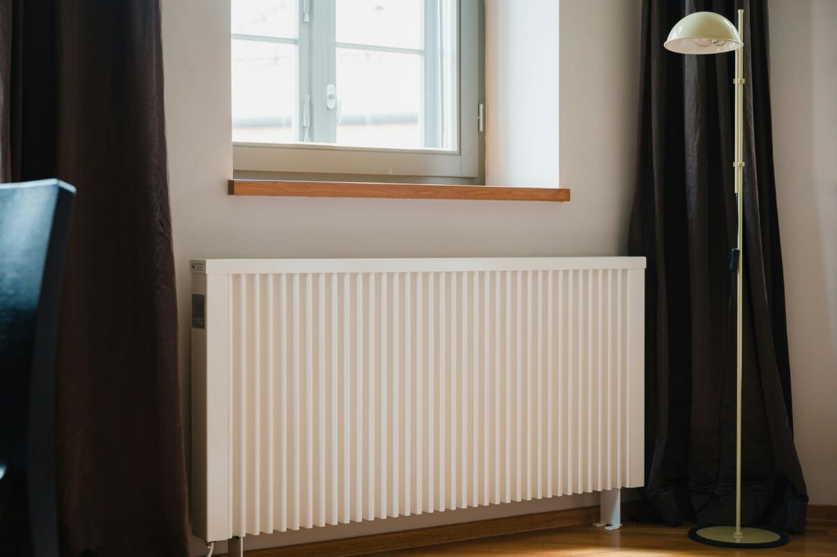 Electric radiator in front of a window.