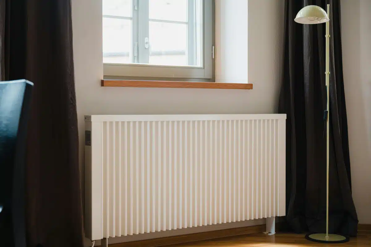 Electric radiator in front of a window.