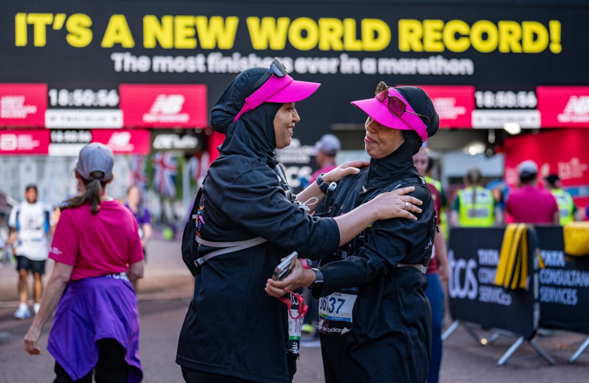 Runners celebrate after crossing the finish line together as a new world record for the most finishers ever in a marathon is completed during The TCS London Marathon on Sunday 27th April 2025.

Photo: Andrew Baker for London Marathon Events