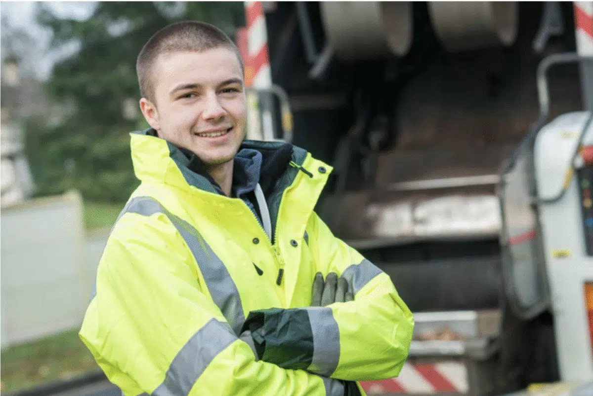 A smiling binman in hi-viz