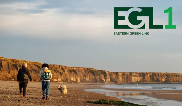 EGL1 funding - two people walking along a beach with a dog