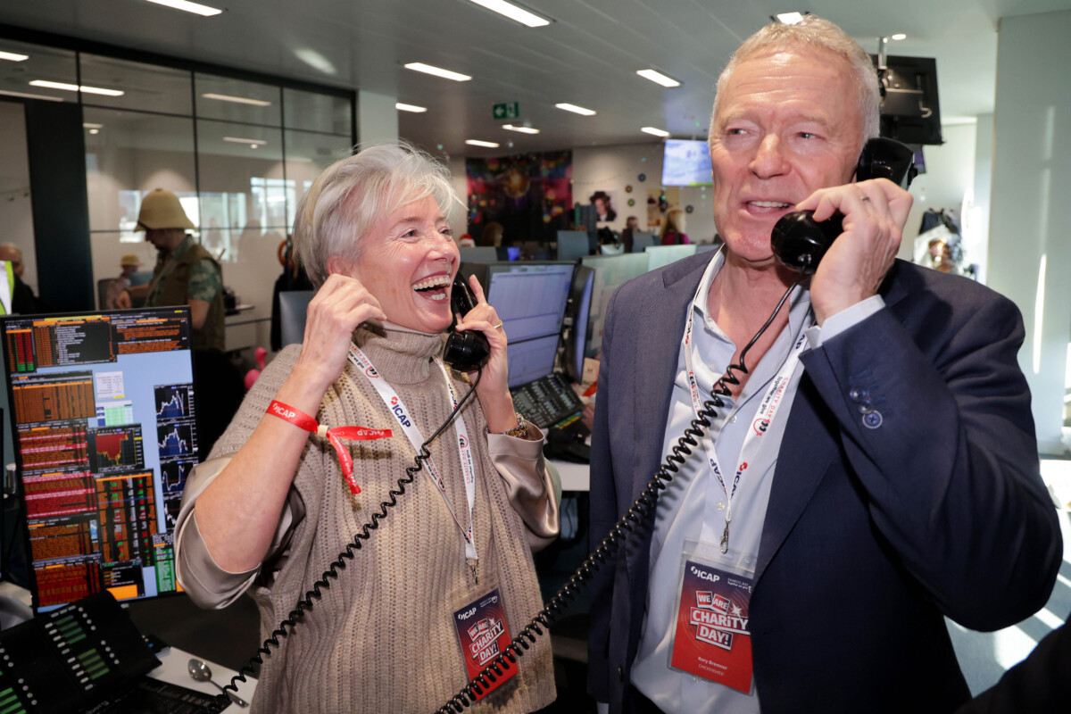 Emma Thompson and Rory Bremner on corded telephones at ICAP Annual Charity Day.