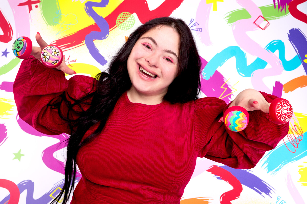 Ellie Goldstein supports Red Nose Day 2026 by wearing one of the new Design-Yer Noses.