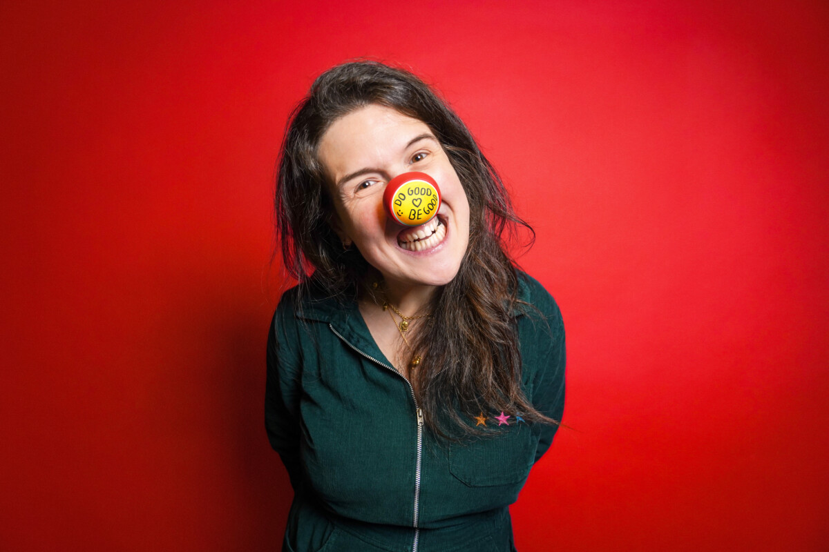 Comedian Rosie Jones supports Red Nose Day 2026 by wearing one of the new Design-Yer Noses.