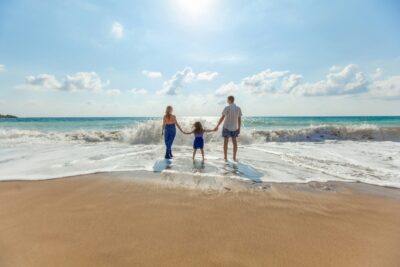 Family at the beach on a sunny day.