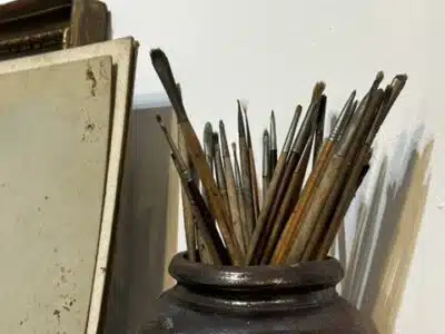 Jar of artist's paintbrushes in a studio at the Munnings Museum, Essex