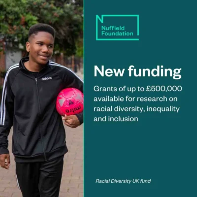 Nuffield Foundaton announces new funding from its racial diversity UK fund. A black youth in a black tracksuit holds a pink football under his arm.