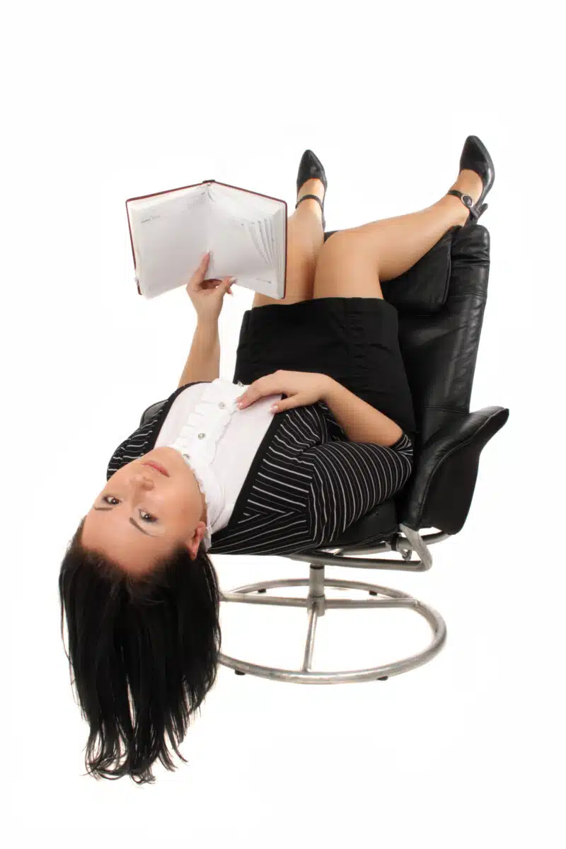 Business girl lounging in a chair Business girl lounging in a chair