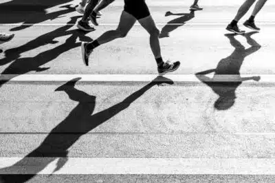 Black and white photos of runners in a city road race.